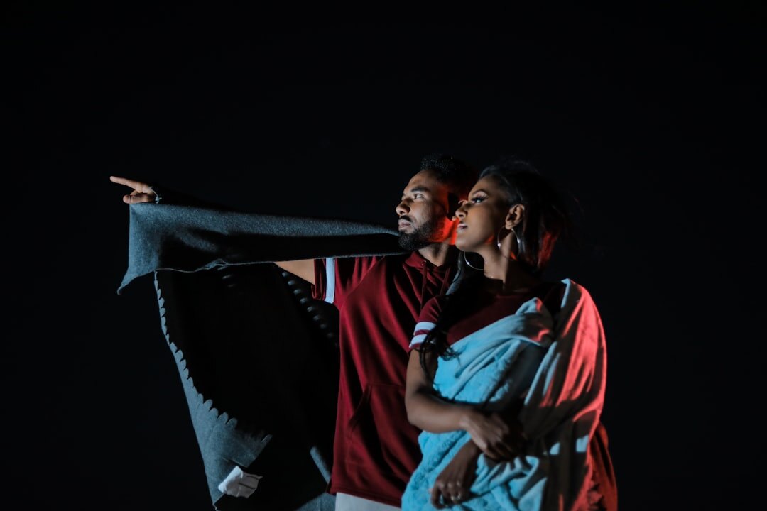 two actors hugging on stage