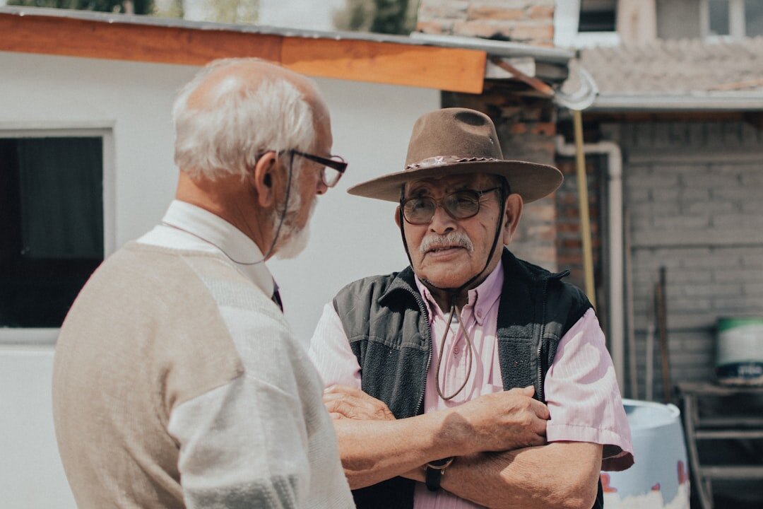 two senior men talking at event