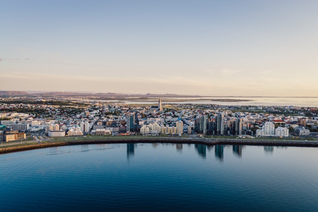 Aerial view of a coastal city skyline at dusk