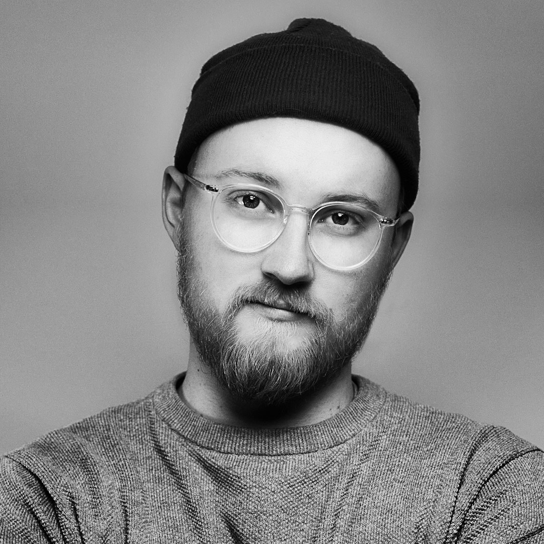 Studio portrait of a man with a beard smiling